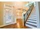Inviting entry with hardwood floors, staircase, and natural light from the front door at 912 Fire Thorn Dr, Hampton, GA 30228