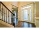Elegant foyer with hardwood floors and decorative glass front door at 912 Fire Thorn Dr, Hampton, GA 30228