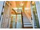 Grand foyer featuring hardwood floors, a staircase, and a stunning chandelier at 912 Fire Thorn Dr, Hampton, GA 30228