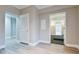 Neutral hallway with hardwood style floors and an open doorway at 912 Fire Thorn Dr, Hampton, GA 30228