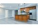 Well-lit kitchen with stainless steel appliances, wood cabinets, granite countertops, and an island at 912 Fire Thorn Dr, Hampton, GA 30228