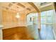 Open-concept living space with hardwood floors, a coffered ceiling, and large windows at 912 Fire Thorn Dr, Hampton, GA 30228