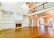 Cozy living room with a fireplace, built-in shelving, and an adjacent staircase to the second floor at 912 Fire Thorn Dr, Hampton, GA 30228