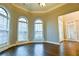 Bright living room with hardwood floors, arched windows, and neutral decor at 912 Fire Thorn Dr, Hampton, GA 30228