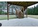 View of the ground level patio area with staircase leading up to the backyard at 912 Fire Thorn Dr, Hampton, GA 30228