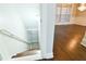 Staircase leading down, view into the living room with hardwood floors at 912 Fire Thorn Dr, Hampton, GA 30228