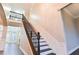 A staircase with wood treads and iron railing leads to the second floor at 912 Fire Thorn Dr, Hampton, GA 30228