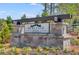 Stone entrance sign for the Heritage River community with green landscaping and wooden fence at 217 Groveton Ct, Euharlee, GA 30145