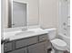 Bathroom with gray vanity, toilet, tub, and large mirror; a perfect blend of style and function at 313 Skye Ln # 49, Cartersville, GA 30121