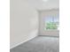 Bright bedroom with plush carpeting, a window overlooking the green landscape, and ample space at 313 Skye Ln # 49, Cartersville, GA 30121