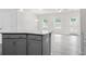 Open-concept kitchen featuring a granite island, gray cabinets, and hardwood flooring with views into living area at 313 Skye Ln # 49, Cartersville, GA 30121