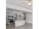 Open-concept kitchen with stainless steel appliances, grey cabinets, granite countertop island, and hardwood floors at 313 Skye Ln # 49, Cartersville, GA 30121