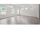 Open-concept living area featuring hardwood floors, a ceiling fan, chandelier, and a sliding glass door to backyard at 313 Skye Ln # 49, Cartersville, GA 30121