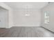 Open living area with neutral walls, hardwood floors, bright windows, modern chandelier and a doorway entrance at 313 Skye Ln # 49, Cartersville, GA 30121