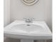 Elegant white pedestal sink in a half bathroom offers a simple and elegant design at 313 Skye Ln # 49, Cartersville, GA 30121