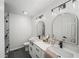 Modern bathroom featuring double sinks, quartz counters, modern fixtures, and a glass enclosed shower at 3951 Covered Bridge Sw Rd, Smyrna, GA 30082