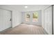 The bedroom is carpeted with two windows, a closet, and a door to the hallway at 3951 Covered Bridge Sw Rd, Smyrna, GA 30082