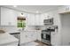 Bright kitchen featuring white cabinets, stainless steel appliances, and modern countertops at 3951 Covered Bridge Sw Rd, Smyrna, GA 30082