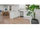 Modern white kitchen with stainless steel appliances and view into breakfast nook at 3951 Covered Bridge Sw Rd, Smyrna, GA 30082