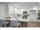 Modern kitchen with white cabinets, stainless steel appliances, and a stylish island with seating at 3951 Covered Bridge Sw Rd, Smyrna, GA 30082