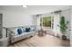 Bright living room featuring a comfortable sofa, stylish decor, and a large window with scenic views at 3951 Covered Bridge Sw Rd, Smyrna, GA 30082