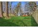 Secluded backyard features a well-maintained lawn, wooden fence, and a cozy deck, creating a serene outdoor space at 4179 Hanes Dr, Decatur, GA 30035