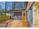 Spacious deck attached to a home with gray siding and a yellow door at 4179 Hanes Dr, Decatur, GA 30035