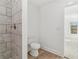 Bathroom featuring a toilet and view into the next room through an open doorway at 4179 Hanes Dr, Decatur, GA 30035