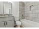 A full bath with tub, gray vanity and granite countertop at 4179 Hanes Dr, Decatur, GA 30035