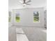 Spacious bedroom with neutral carpet, ceiling fan, and lots of natural light at 4179 Hanes Dr, Decatur, GA 30035