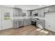 Modern kitchen with gray cabinets, granite countertops, and stainless steel appliances at 4179 Hanes Dr, Decatur, GA 30035