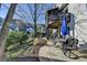 Backyard with stone patio featuring seating, and lush landscaping at 7115 Harbour Lndg, Alpharetta, GA 30005