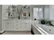 Bathroom featuring dual vanities, framed mirrors, soaking tub, and ample counter space at 7115 Harbour Lndg, Alpharetta, GA 30005
