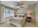 Comfortable bedroom featuring a ceiling fan, natural light, and neutral decor at 7115 Harbour Lndg, Alpharetta, GA 30005