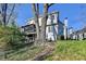 Expansive rear elevation view with large deck and two chimneys on a sunny day at 7115 Harbour Lndg, Alpharetta, GA 30005