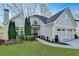 Charming two-story home featuring a landscaped yard, attached two-car garage and neutral color palette at 7115 Harbour Lndg, Alpharetta, GA 30005