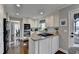 Bright kitchen with white cabinets, stainless appliances and a granite island cooktop at 7115 Harbour Lndg, Alpharetta, GA 30005
