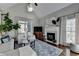Bright living room boasts vaulted ceilings, fireplace, large windows, and hardwood flooring at 7115 Harbour Lndg, Alpharetta, GA 30005