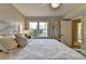 Bright main bedroom featuring neutral tones, a ceiling fan, and natural light at 7115 Harbour Lndg, Alpharetta, GA 30005