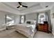 Spacious main bedroom boasts a tray ceiling, neutral decor, and comfortable furnishings, creating a relaxing retreat at 7115 Harbour Lndg, Alpharetta, GA 30005
