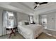 Relaxing main bedroom showcases a tray ceiling, soft gray walls, and a peek into the luxurious bathroom at 7115 Harbour Lndg, Alpharetta, GA 30005