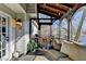 Relaxing screened porch boasts wood ceiling and outdoor seating at 7115 Harbour Lndg, Alpharetta, GA 30005