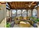 Inviting screened porch with comfortable wicker furniture and neighborhood views at 7115 Harbour Lndg, Alpharetta, GA 30005