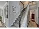 Inviting staircase with neutral carpet and white railings leads to the upper level of the home at 7115 Harbour Lndg, Alpharetta, GA 30005