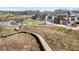 Scenic aerial view of a community featuring a pond, amphitheater, and a wooden walking path at 1645 Renfroe Run, Cumming, GA 30041