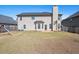 Expansive backyard with healthy lawn, mature trees, and privacy fence, ideal for outdoor enjoyment at 1645 Renfroe Run, Cumming, GA 30041