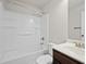 This bathroom features a shower-tub combo with bright-white fixtures and dark-wood cabinets at 1645 Renfroe Run, Cumming, GA 30041