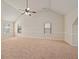 Spacious bedroom with vaulted ceiling and neutral carpet, filled with natural light from multiple windows at 1645 Renfroe Run, Cumming, GA 30041