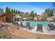 Relax poolside at this community pool featuring comfortable lounge chairs and tables for socializing at 1645 Renfroe Run, Cumming, GA 30041