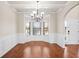 Elegant dining room with wainscoting, hardwood floors, and a chandelier at 1645 Renfroe Run, Cumming, GA 30041
